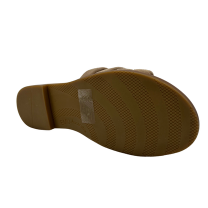 Bottom view of taupe suede slip on sandal with padded upper and footbed. Cross strap design and low heel.