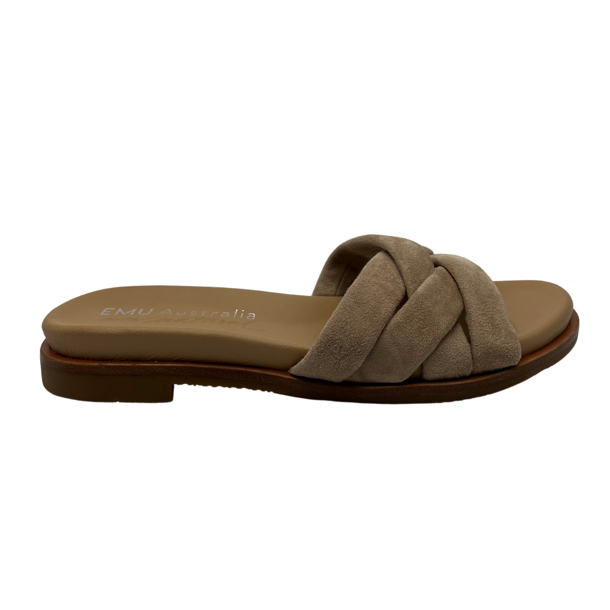 Right facing view of taupe suede slip on sandal with padded upper and footbed. Cross strap design and low heel.