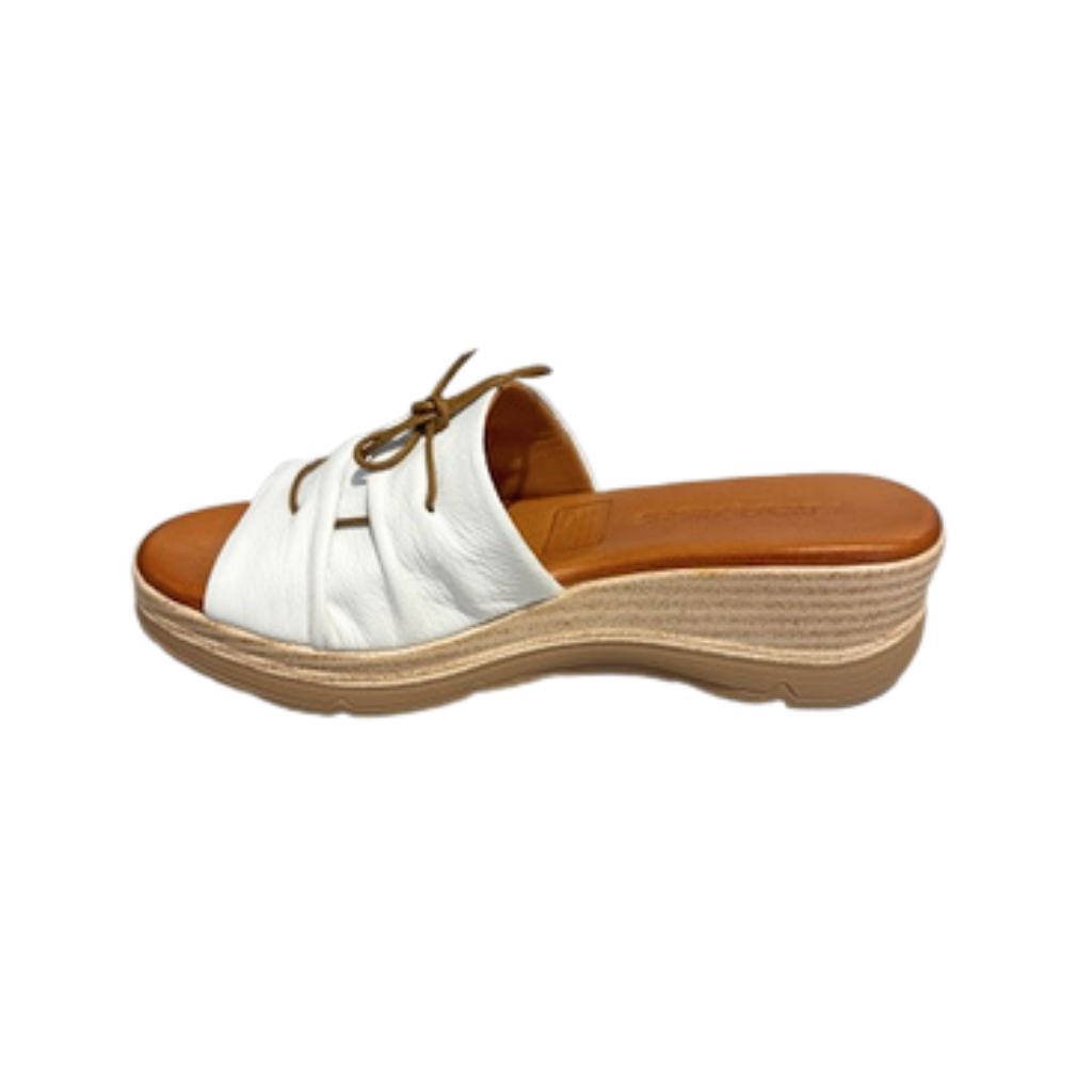 White sandal with brown sole on a white background