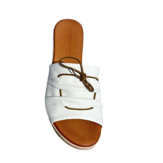 White sandal with brown sole on a white background