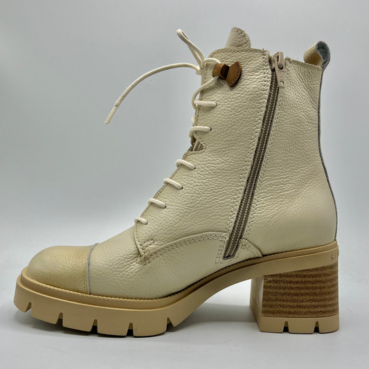 Beige leather boot with a zipper on a light gray background