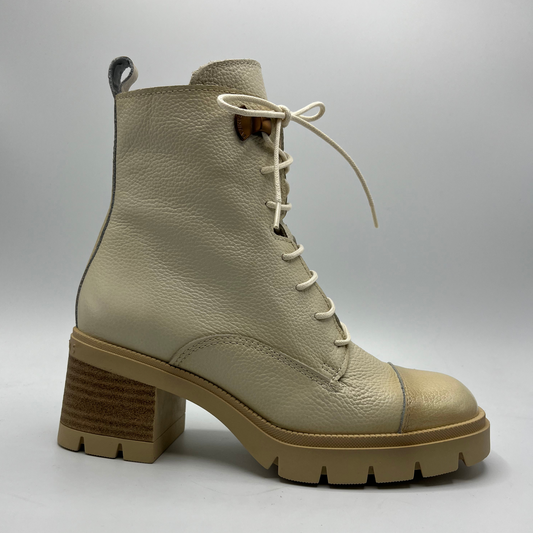 Beige leather boot with a chunky sole on a light gray background