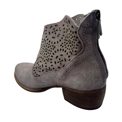 Back facing view of smokey lavender leather short cowboy boot with cutout details and zipper closure