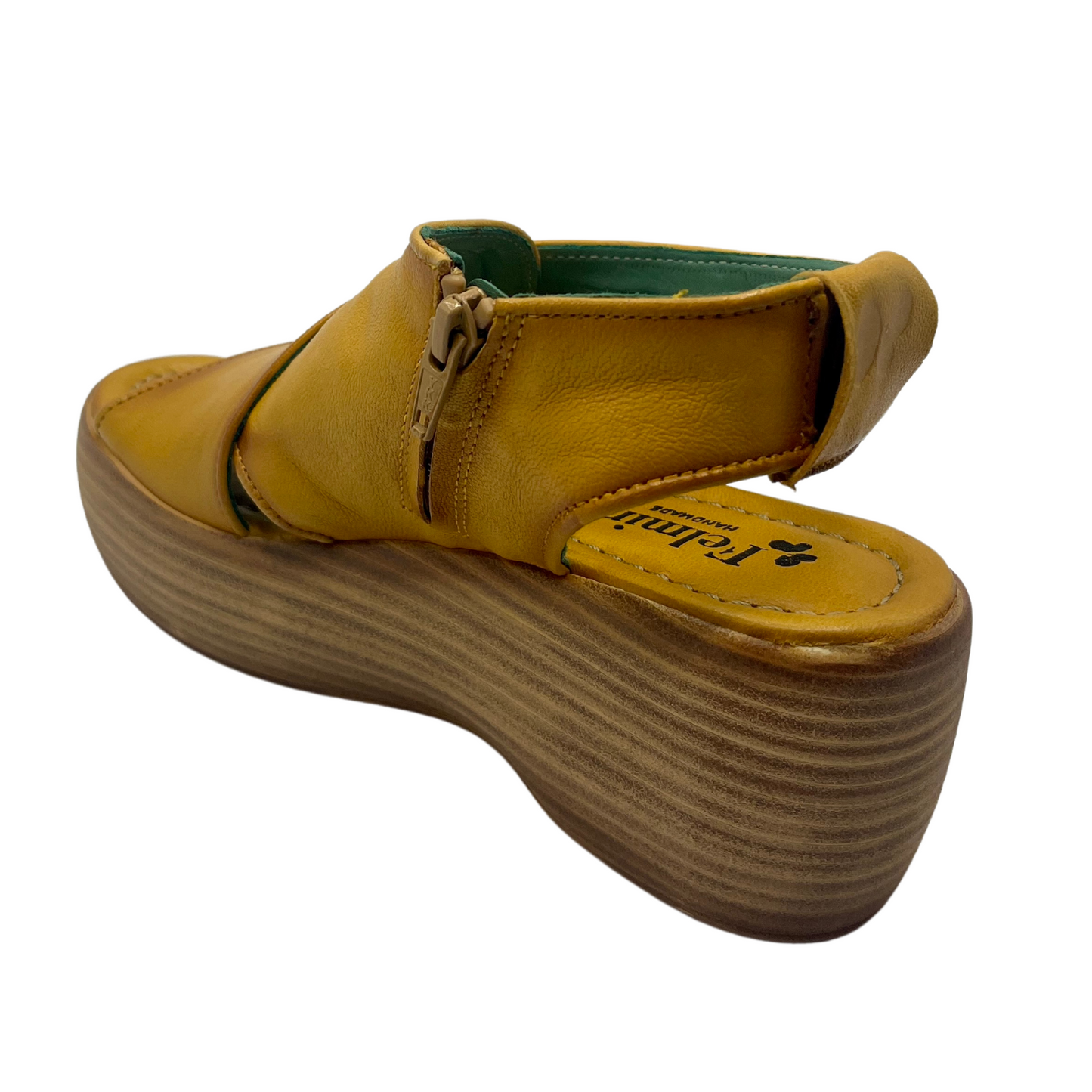 Back view of mustard coloured leather sandals with chunky wedge sole and sling back strap