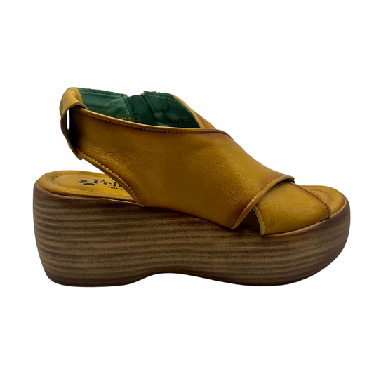 Right facing view of mustard coloured leather sandals with chunky wedge sole and sling back strap