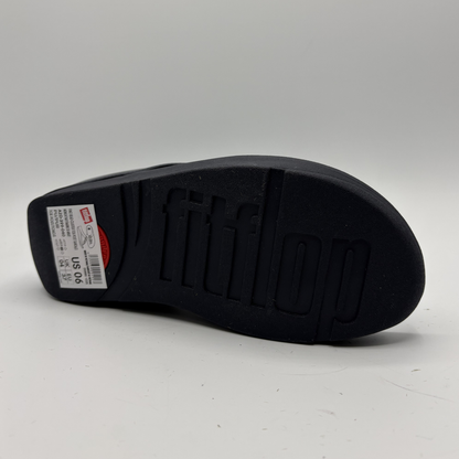 Black shoe sole with brand logo on a gray background