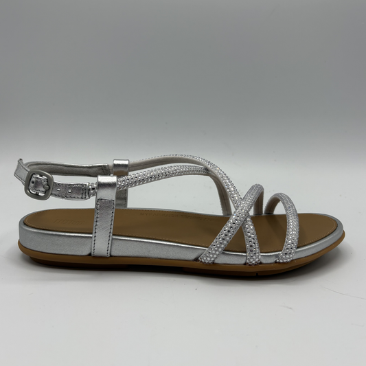 Silver sandal with rhinestone details on a gray background