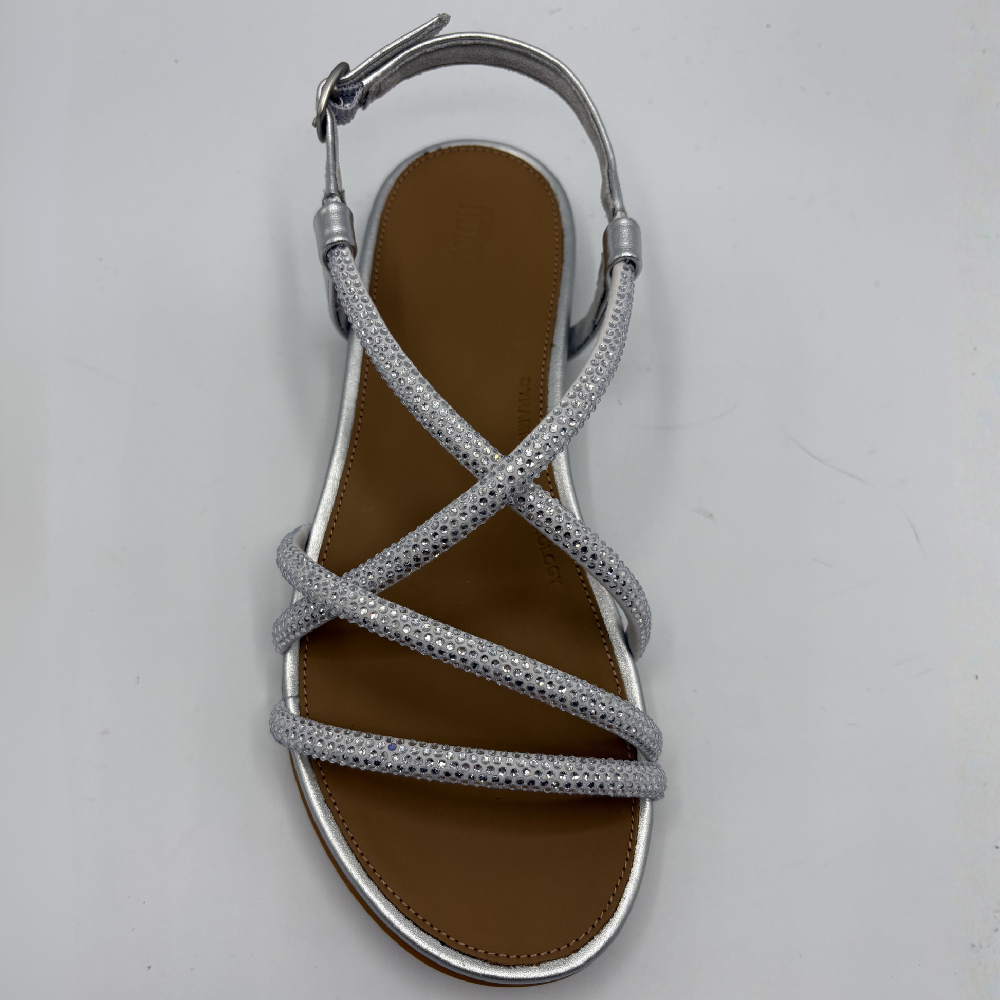 Silver strappy sandal on a light gray background