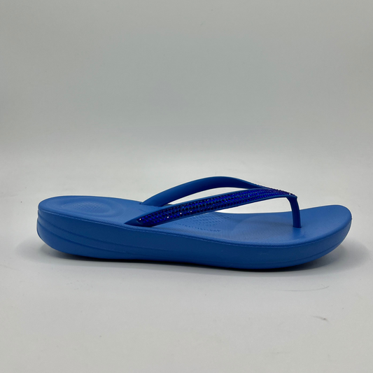 Right facing view of a cushioned blue slip flop sandal with a sparkly strap and cushioned footbed.