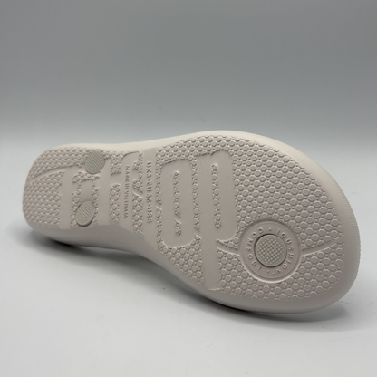 White shoe sole with brand logo on a gray background