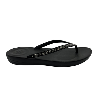 Right facing view of black flip flop with bejewelled thong strap