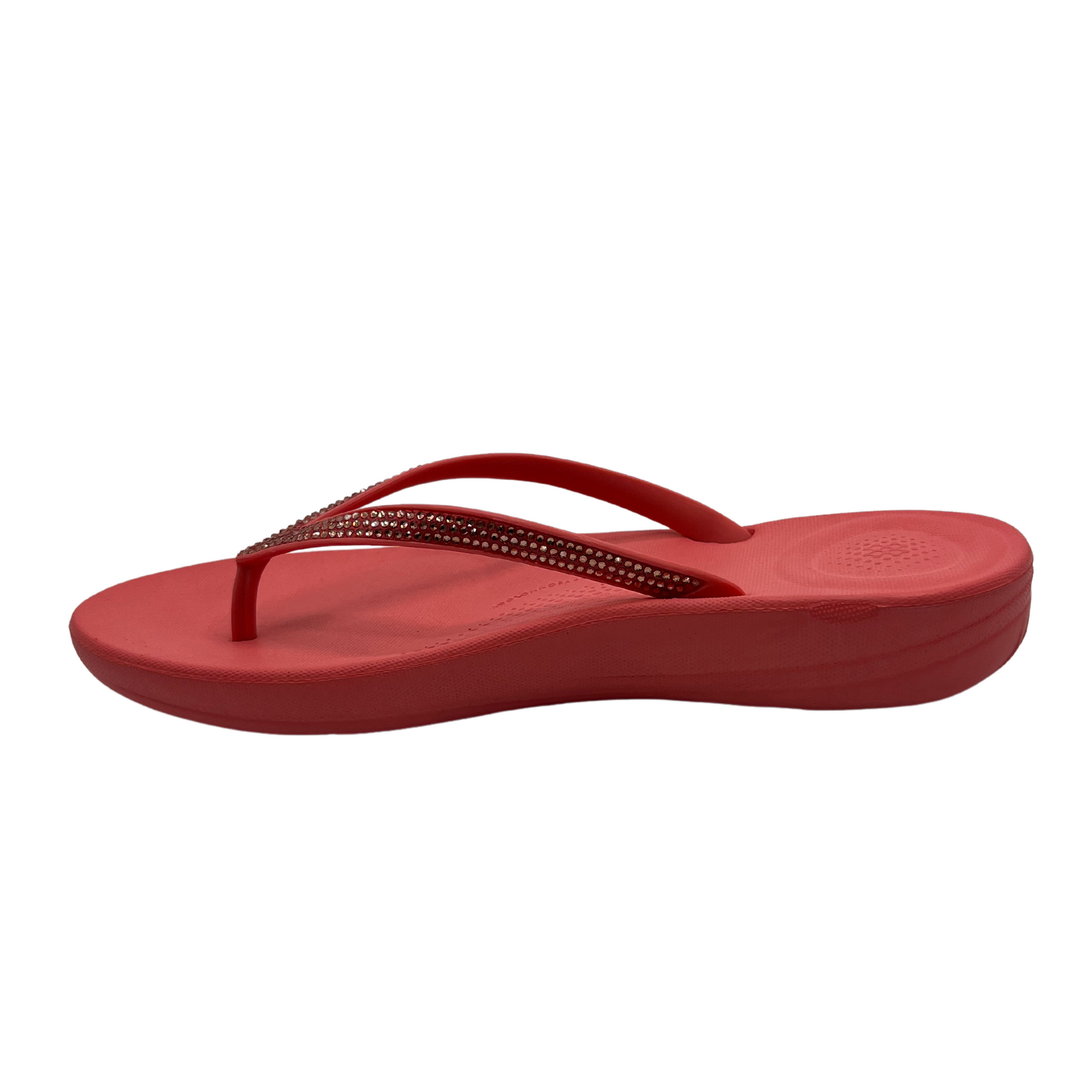 Left facing view of rosy coral flip flop with bejewelled thong strap