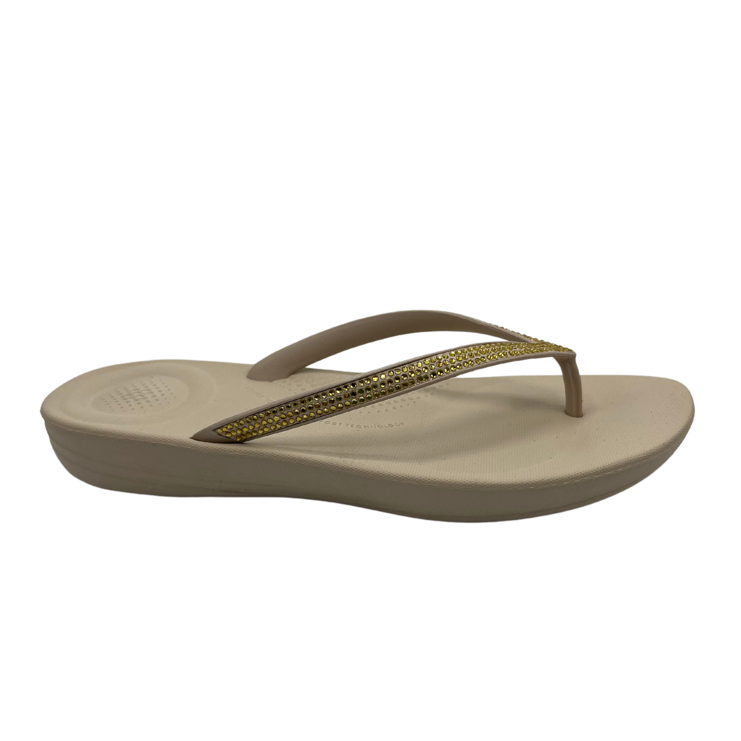 Right facing view of beige flip flop with bejewelled thong strap