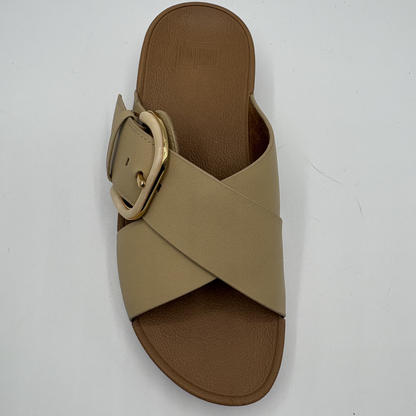 Beige sandal with a gold buckle on a white background