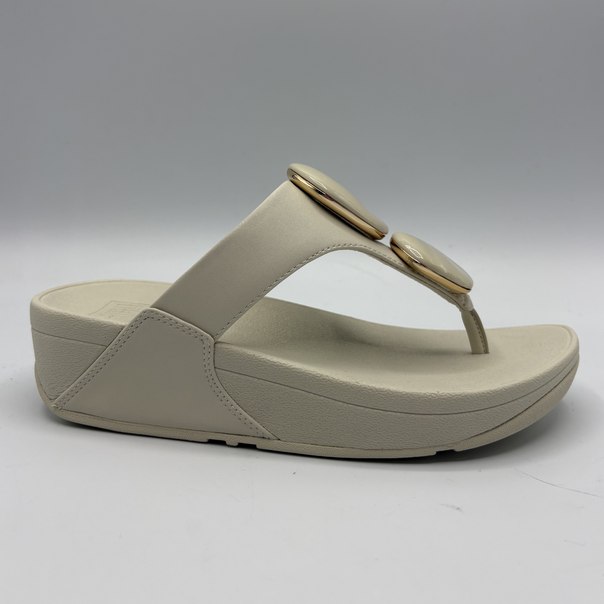 Beige sandal with a thick sole on a white background