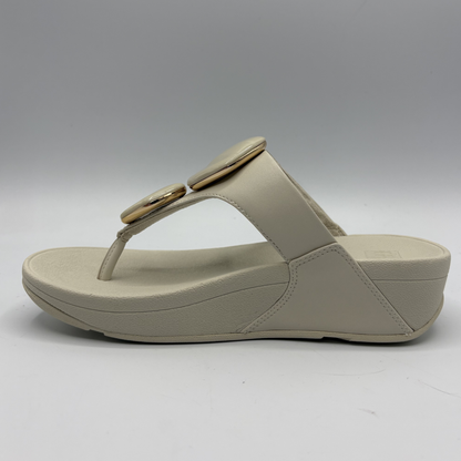 Beige sandal with a wedge heel on a white background