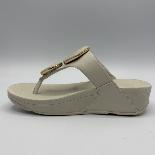 Beige sandal with a wedge heel on a white background