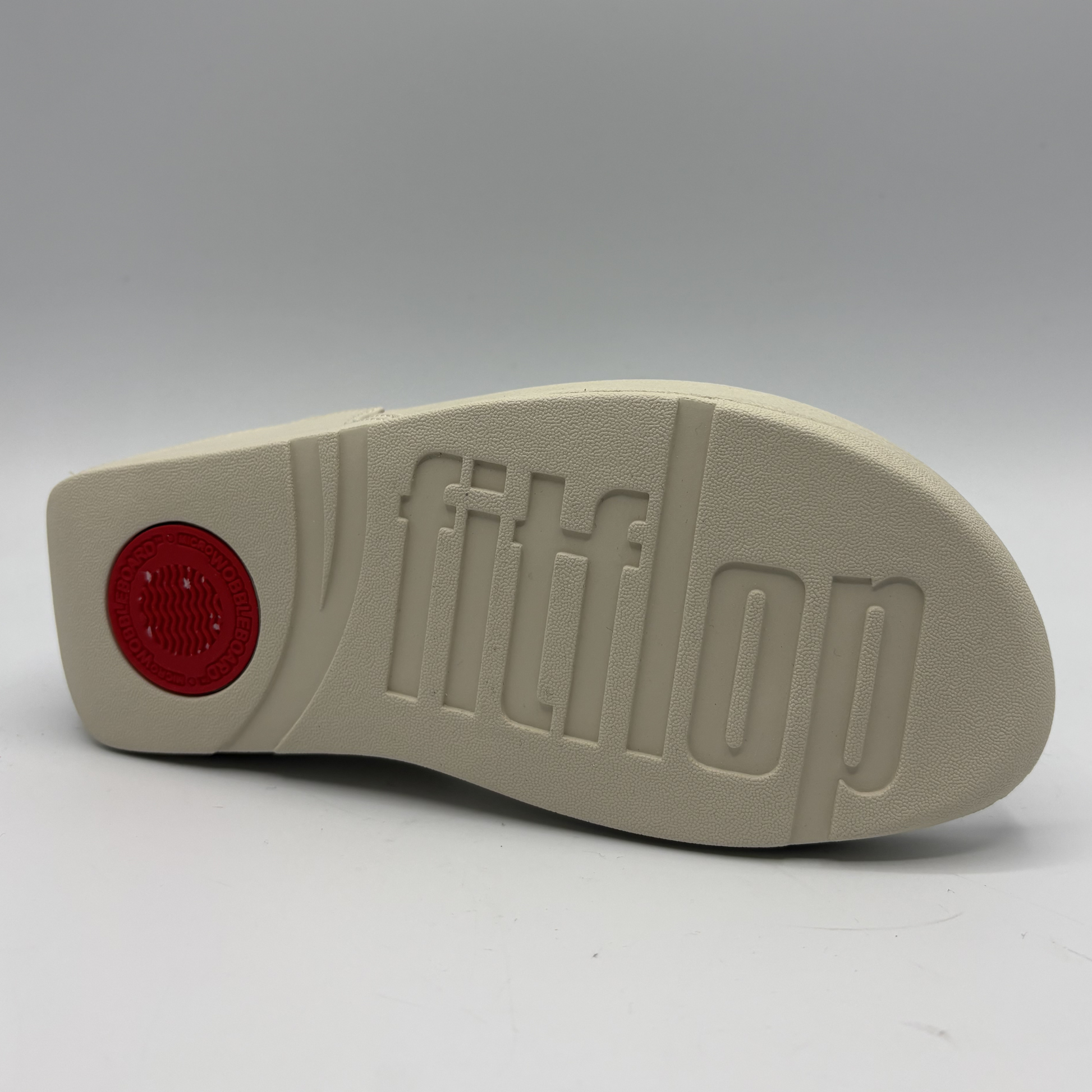 Beige shoe sole with 'fitflop' branding on a white background