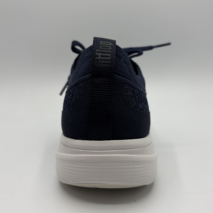 Navy blue sneaker with white sole on a light gray background