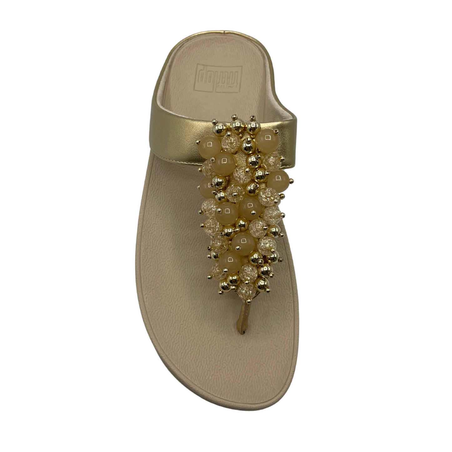 Top view of gold sandals with round embellishments on front strap and lightweight platform sole