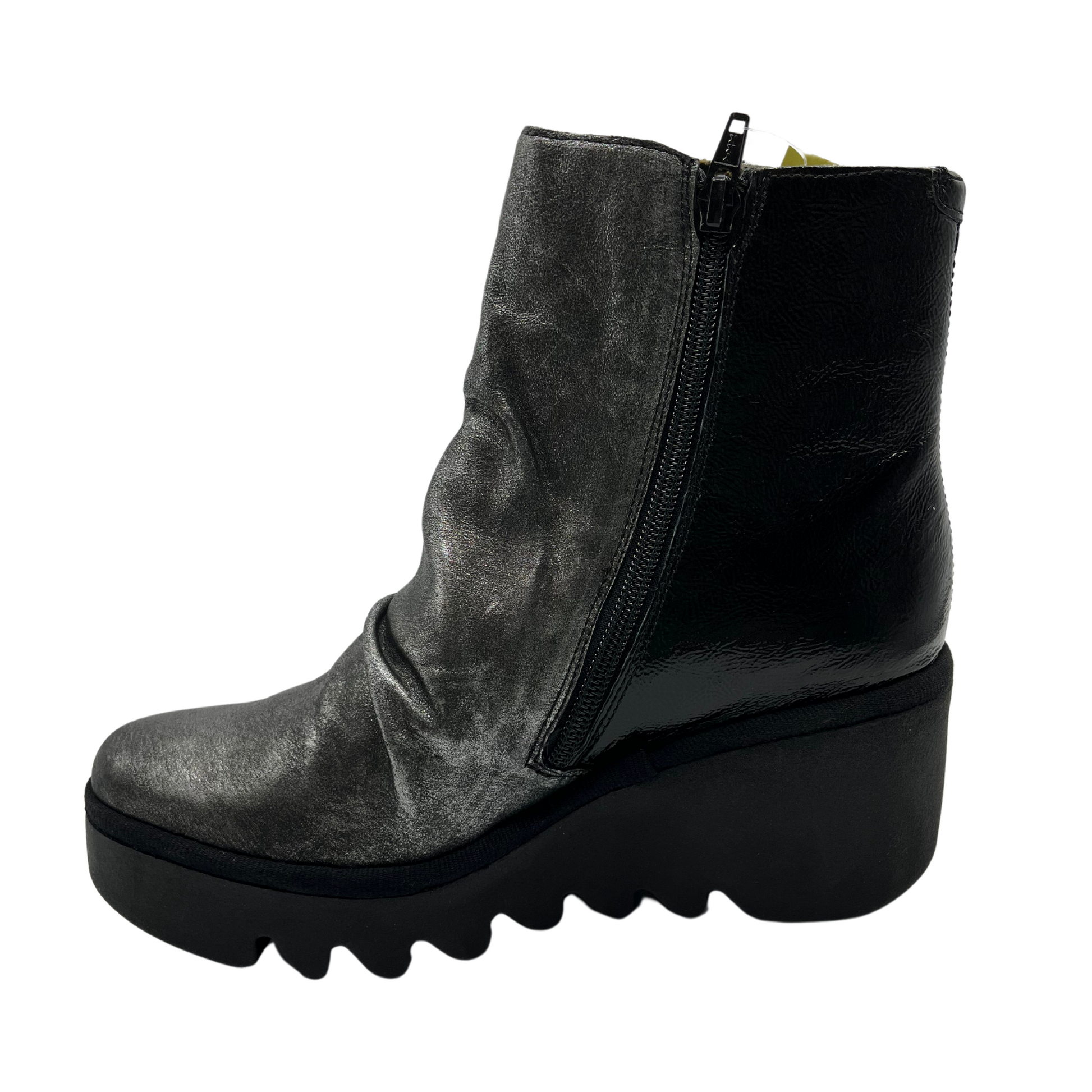 Left facing view of dark silver leather bootie with wedge heel and side zipper closure