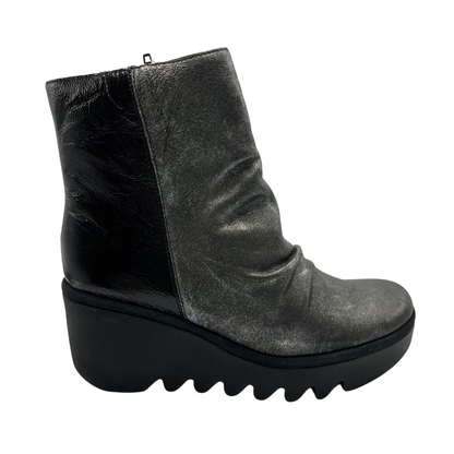 Right facing view of dark silver leather bootie with wedge heel and side zipper closure