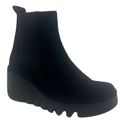 45 degree angled view of black suede boot with chunky wedge heel