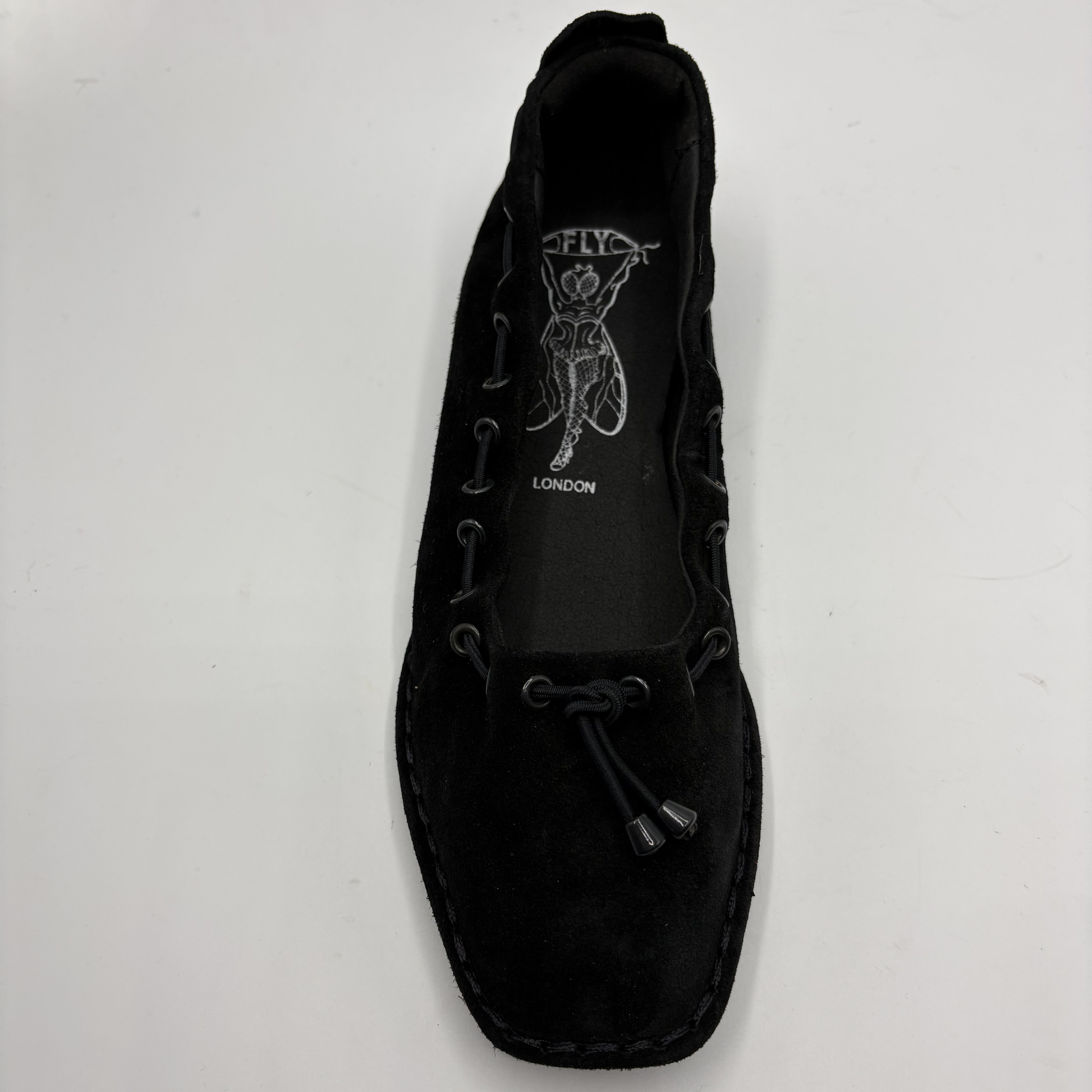 Black ballet flat with branding on a white background