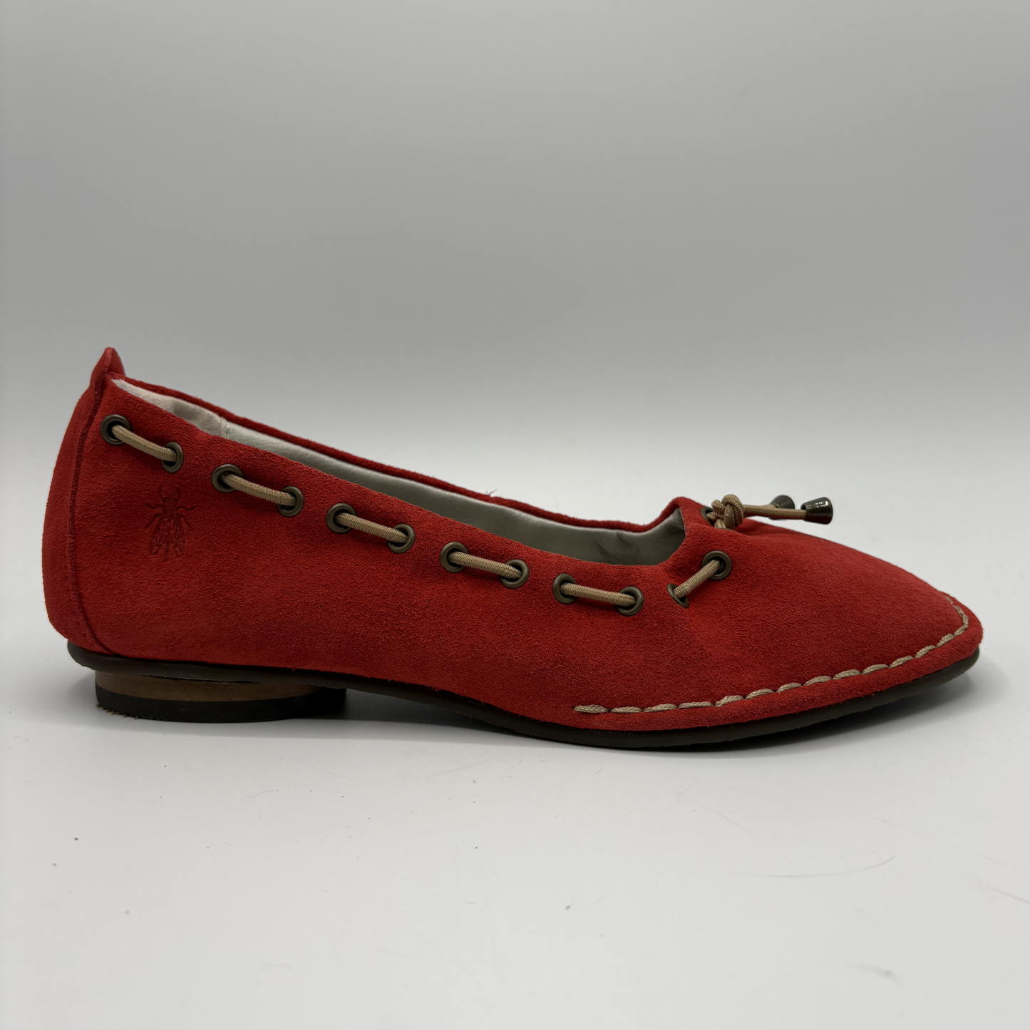 Red flat shoe with brown accents on a white background