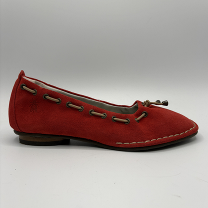 Red flat shoe with brown accents on a white background