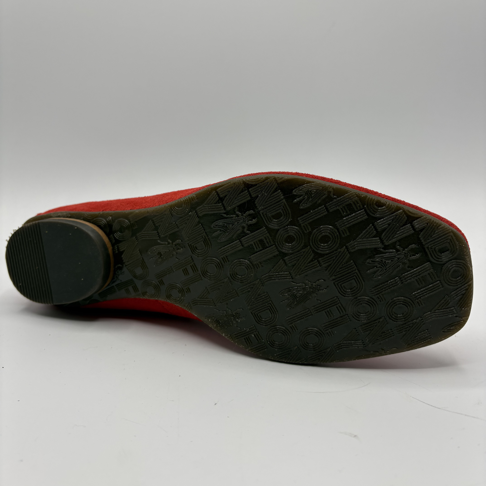 Black sole of a shoe with red upper on a white background