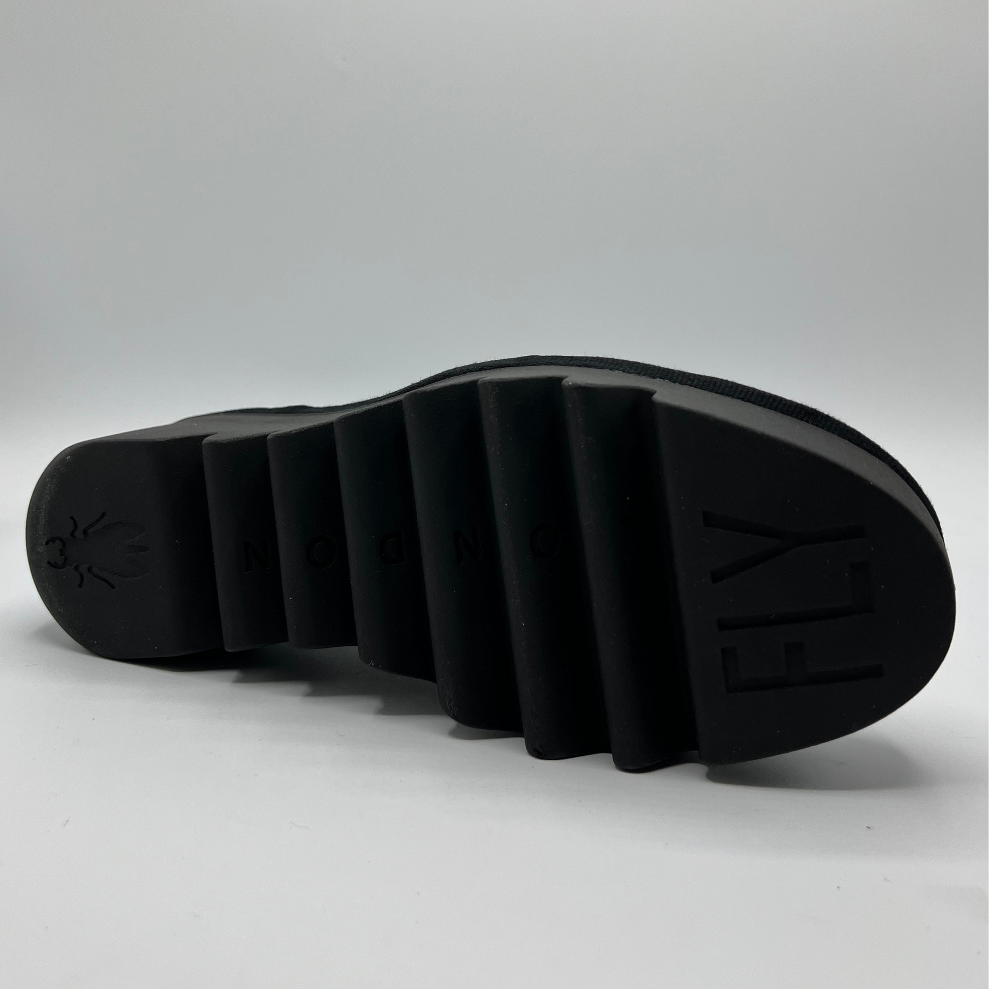Black sole of a shoe on a light gray background