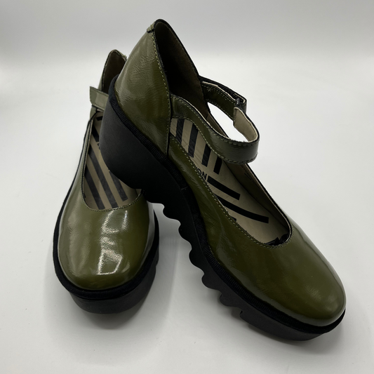 Pair of green shoes with black soles on a white background