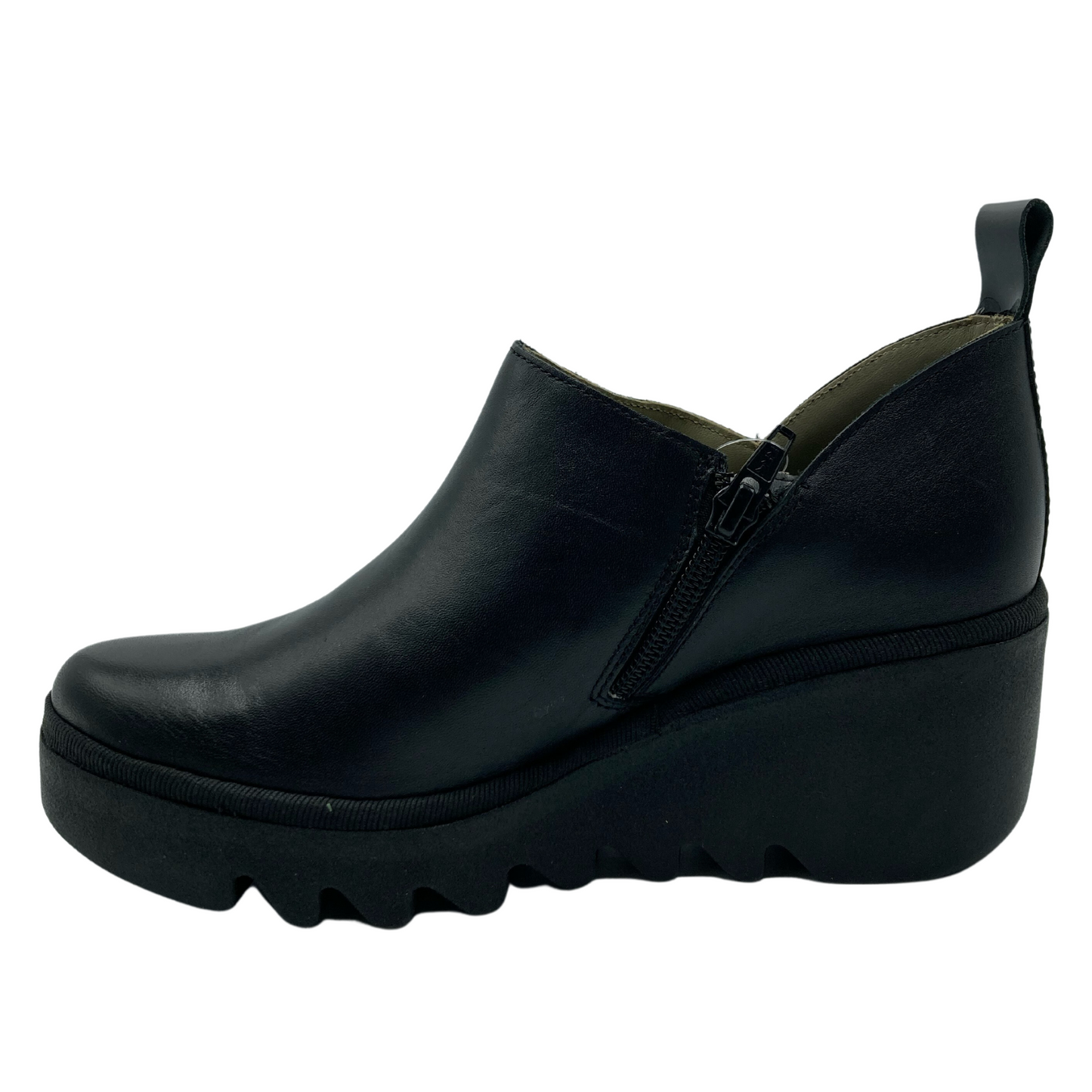 Left facing view of black leather wedge bootie with heel pull tab and zipper closure on the side