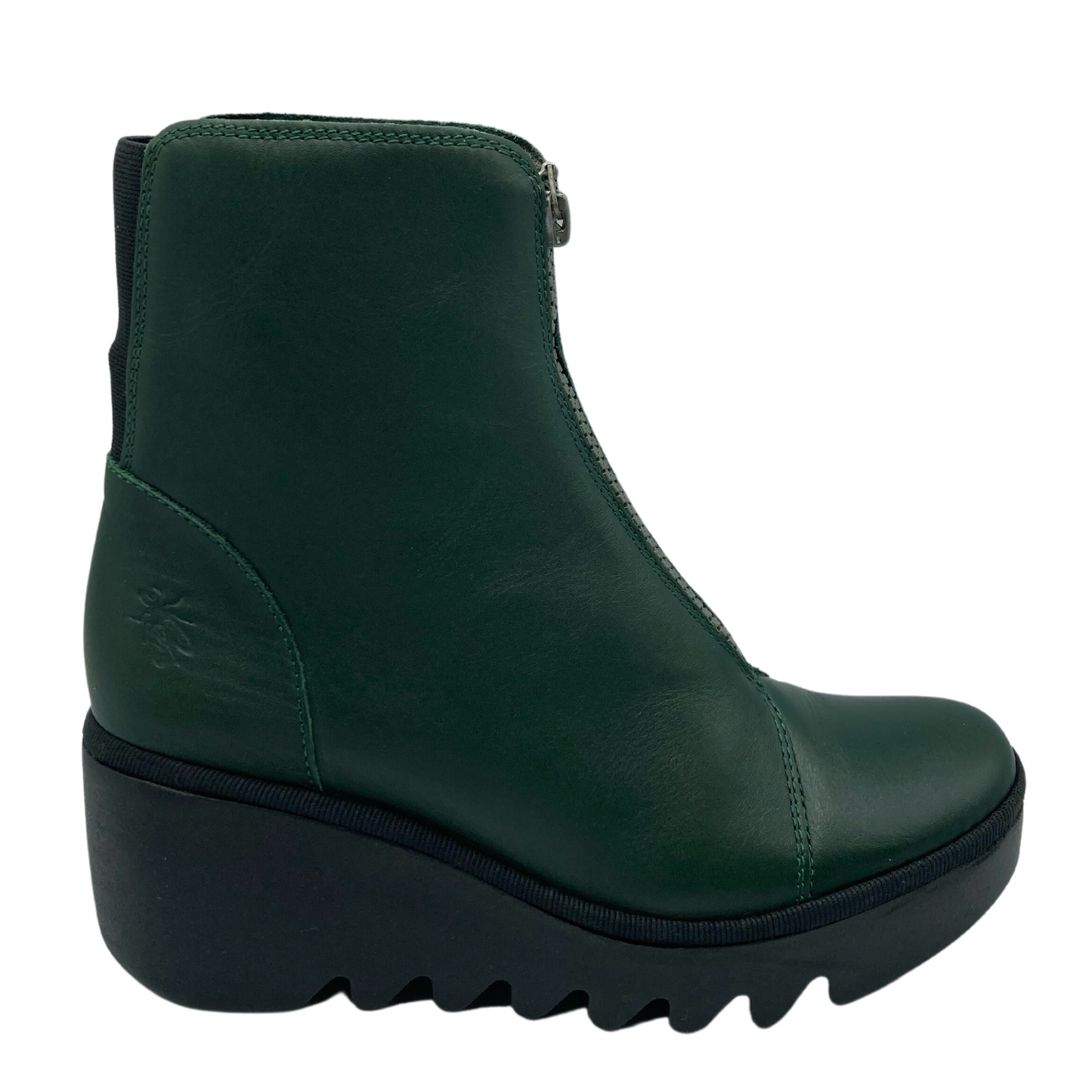 Right facing view of green leather short boot with cleated black wedge heel