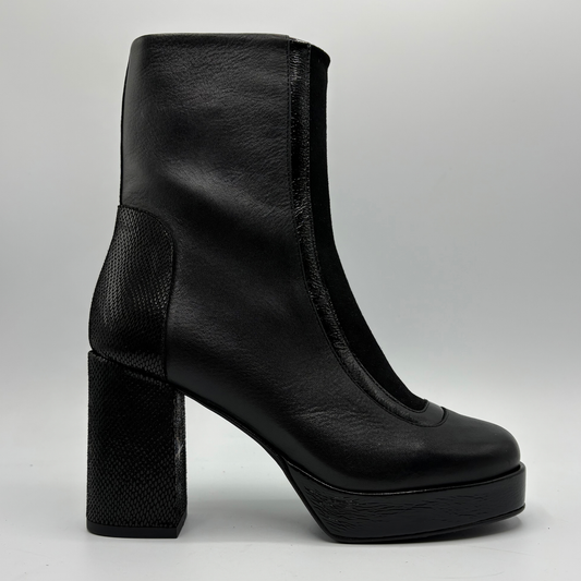 A black leather ankle boot with a chunky block heel, platform sole, and textured side panel, shown in profile against a light gray background.