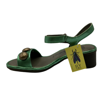 Left view of green leather sandal with rounded toe, velcro strap and block heel