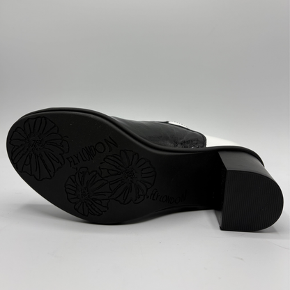 Black leather boot sole with floral embossed details and the brand name visible, photographed on a light gray background.