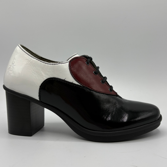 A women's low-heeled oxford-style shoe with a glossy black patent leather toe and quarter, a white leather side panel, and a burgundy leather V-panel on the vamp, finished with black laces and a black block heel.