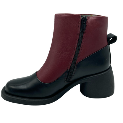 Left facing view of black and red short boot with black zipper closure.