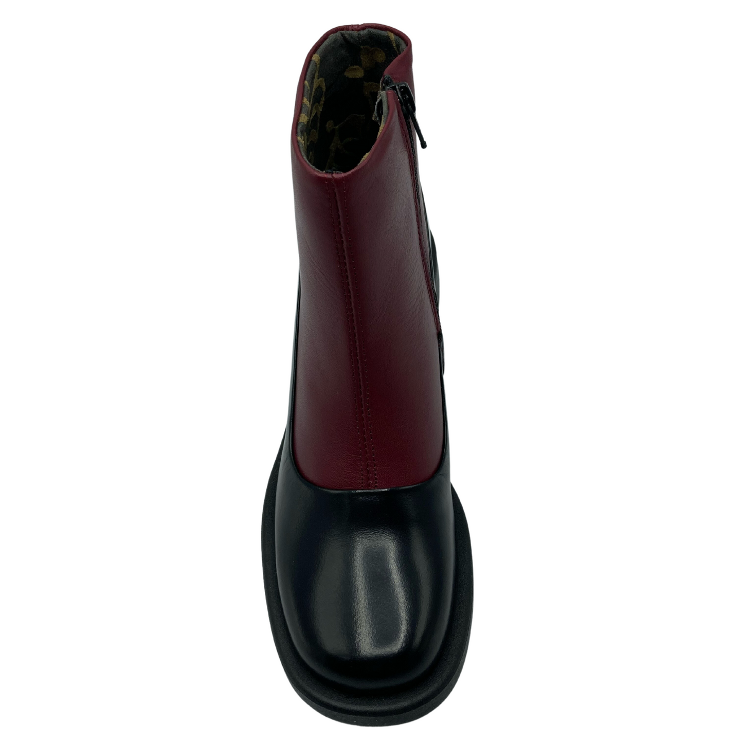 Top view of black and red leather short boot with rounded toe and black sole