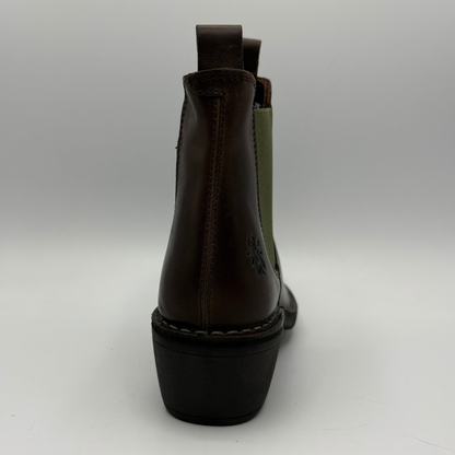 A dark brown leather ankle boot shown from the back, featuring a black block heel, contrast stitching, and a muted olive green elastic side panel on a light gray background.