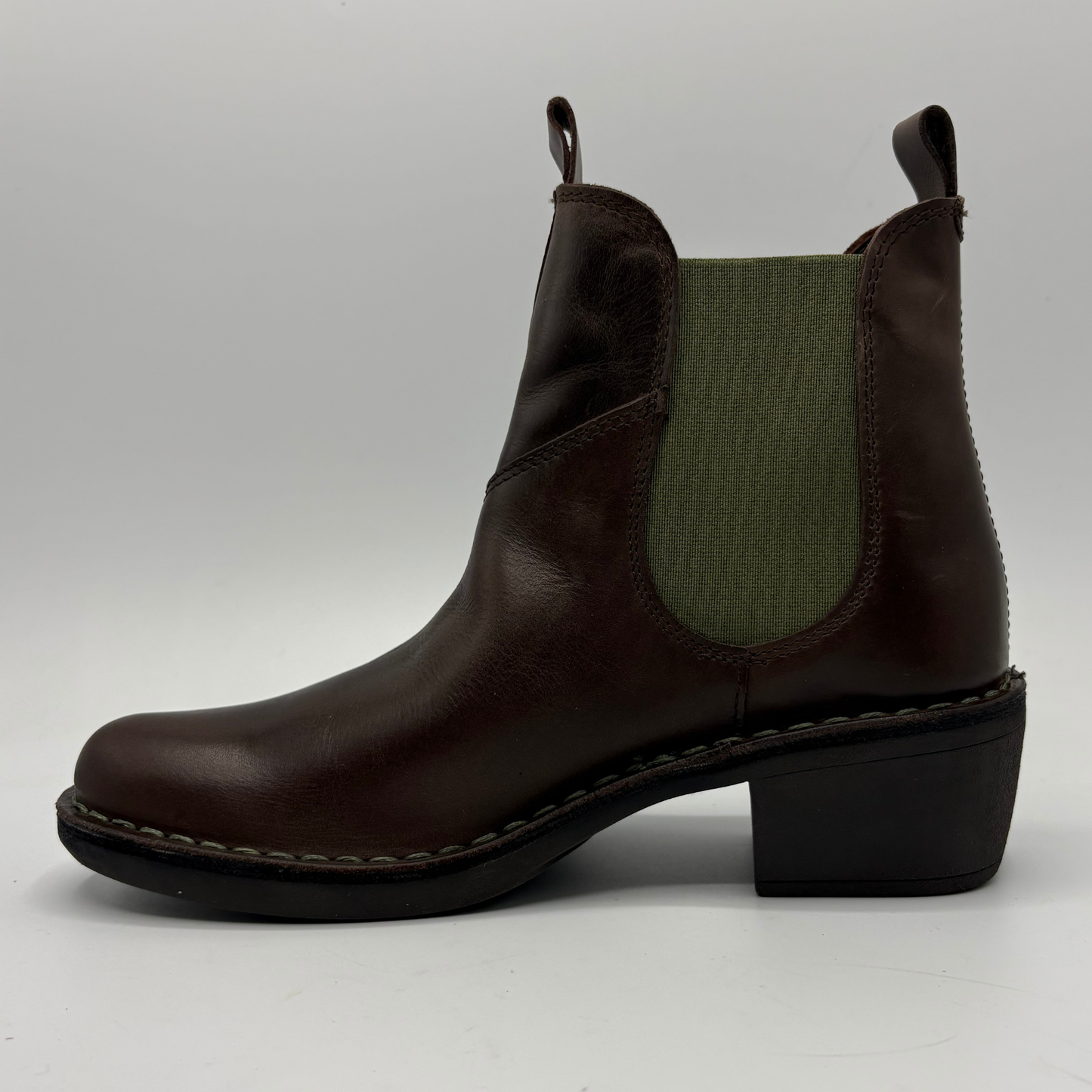 A dark brown leather Chelsea-style ankle boot with an olive green elastic side panel and a black block heel, shown in profile against a light gray background.