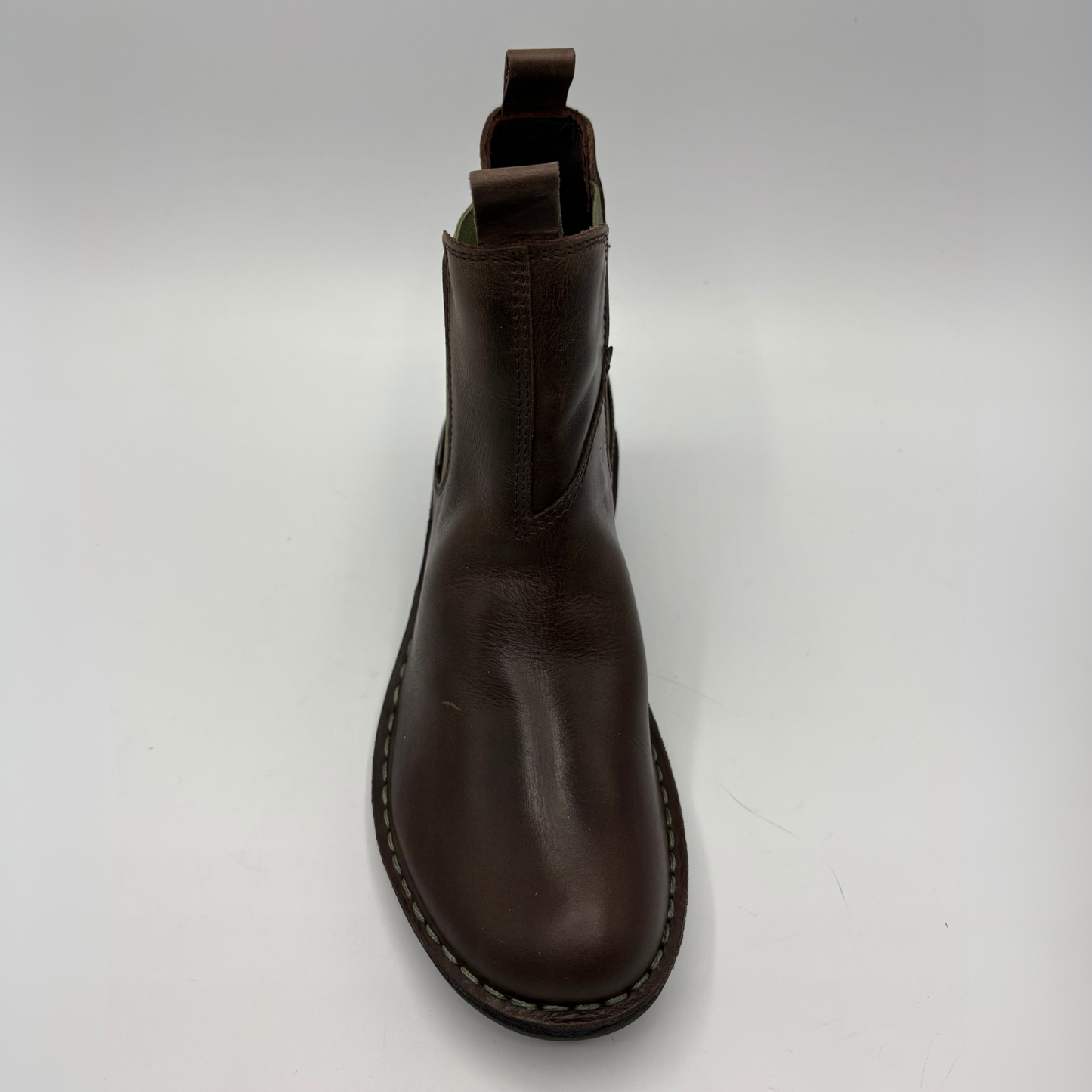 A dark brown leather Chelsea boot shown from a top-down perspective on a light gray background.
