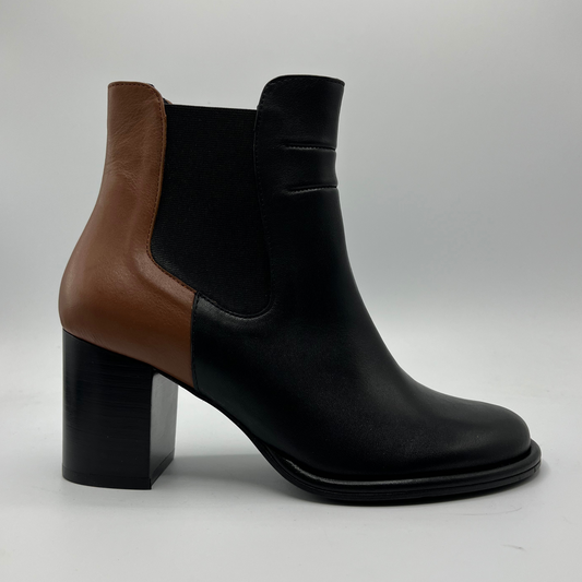 Black and brown ankle boot with black heel on a light gray background