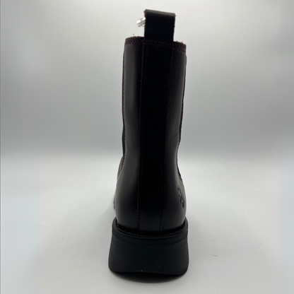 Wine coloured boot on a light gray background