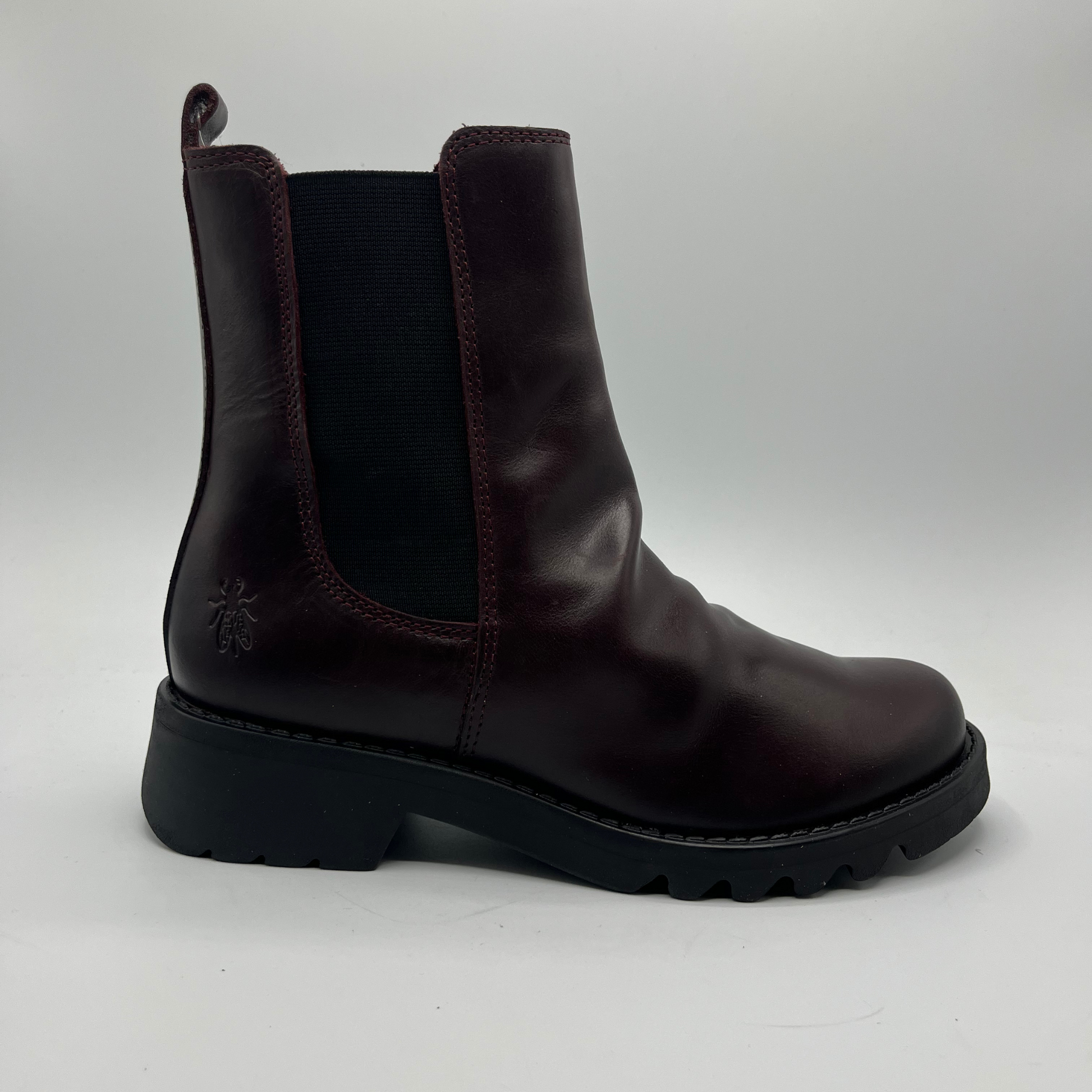 Wine leather boot on a white background
