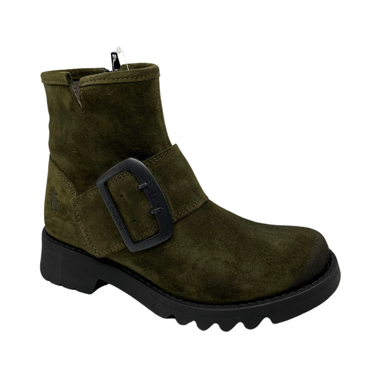 45 degree angled view of green suede short boot with oversized gunmetal buckle, black outsole and side zipper closure