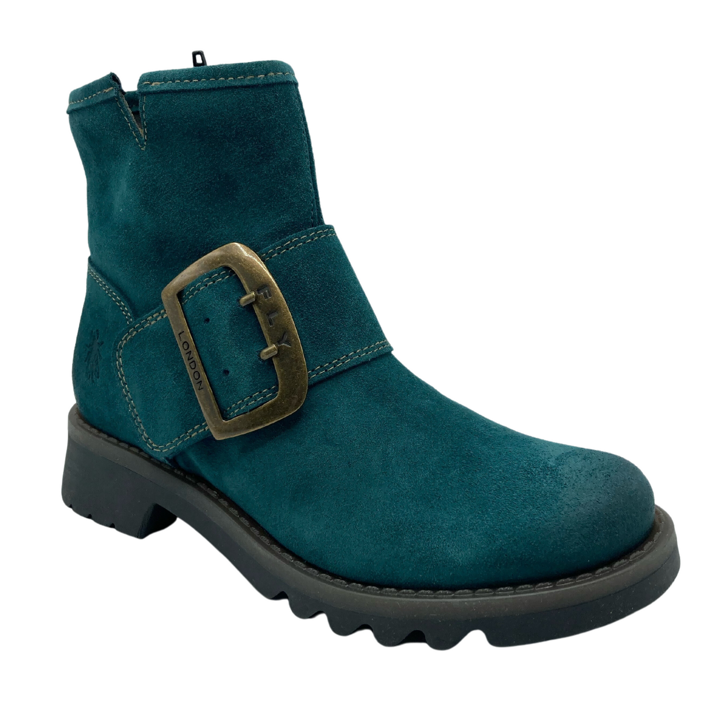 45 degree angled view of a dark cyan suede short boot with large brass buckle detail on the upper strap