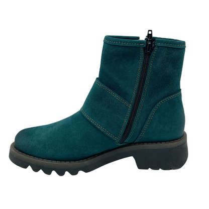 Left facing suede short boot in dark cyan colour. Black zipper closure with grey rubber sole
